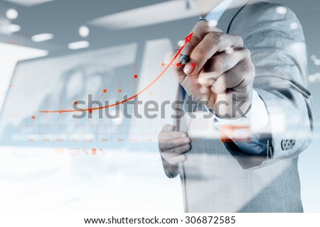 double exposure of businessman hand drawing virtual chart business on touch screen computer