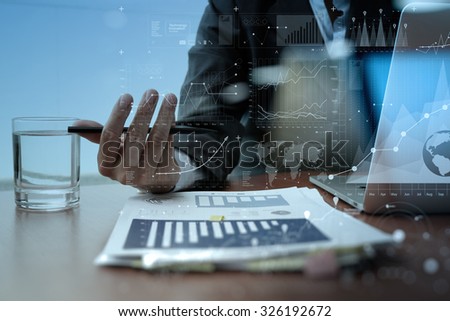 business man hand working on laptop computer with digital layer business strategy and social media diagram on wooden desk