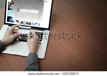top view of hands using laptop and holding credit card with \