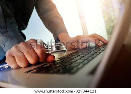 Doctor working at workspace with laptop computer in medical workspace office