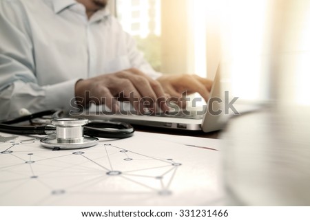 doctor working with laptop computer in medical workspace office and medical network media diagram as concept