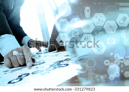 doctor working with laptop computer in medical workspace office and medical digital network media diagram as concept