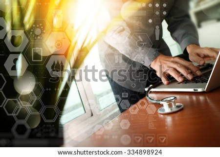Doctor working at workspace with laptop computer in medical workspace office and digital medical layers diagram with green plant foreground