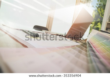 Designer workspace with laptop computer and smart phone and digital tablet with sample pan tone colour on wooden desk as responsive web design concept