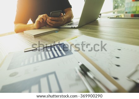 Designer hand working with laptop computer and smart phone and digital tablet on wooden desk as responsive web design concept