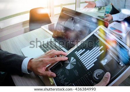 Businessman making presentation with his colleagues and business tablet digital computer at the office as concept
