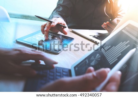Business team meeting present. Photo professional investor working new startup project. Finance meeting.Digital tablet laptop computer  smart phone using, keyboard docking screen foreground,filter
