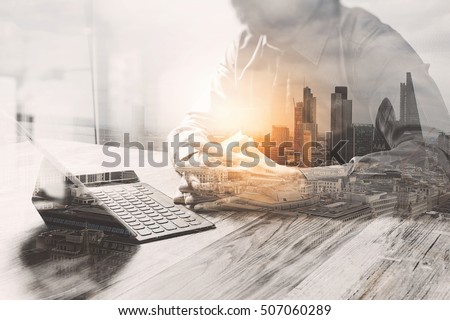 Double Exposure,businessman working with new start up project.using smart phone digital tablet docking keyboard on wooden desk,sun effect
