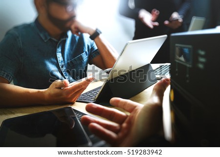 Start Up Programming Team. Website designer working digital tablet dock keyboard and computer laptop with smart phone and compact server on mable desk,light effect