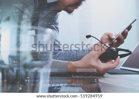 Man using VOIP headset with digital tablet computer docking smart keyboard, concept communication, it support, call center,digital screen graphic virtual icons,graph,diagram