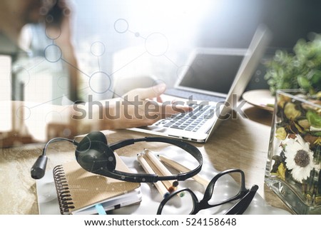 Man using VOIP headset with digital tablet computer docking smart keyboard, concept communication, it support, call center and customer service help desk,filter film effect