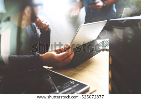 Start Up Programming Team. Website designer working digital tablet dock keyboard and computer laptop with smart phone and compact server on mable desk,light effect