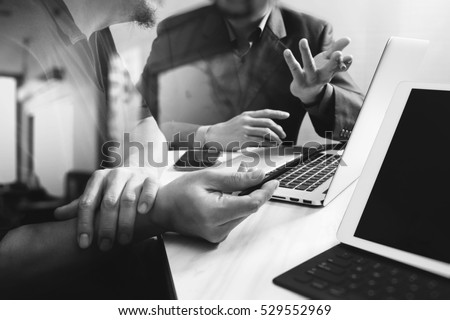 Business team meeting. Photo professional investor working new start up project. Finance task.Digital tablet docking keyboard laptop computer smart phone using, black white