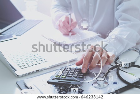 Healthcare costs and fees concept.Hand of smart doctor used a calculator for medical costs in modern hospital with VR icon diagram