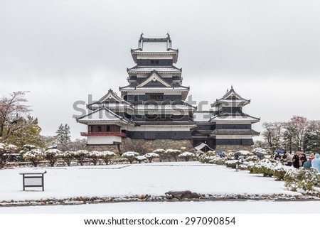 Matsumoto Castle (Crow Castle) covered under snow in winter, Japan The keep (tenshukaku) maintains its original wooden interiors and external stonework