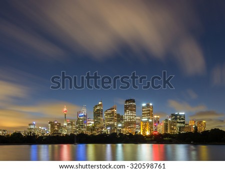 Sydney Skyline, Sydney Landmark, Sydney Tower and Sydney City CBD at night with blue sky blur cloud long exposure and Reflection From circular quay from Mrs Macquarie's Chair in Summer, Australia