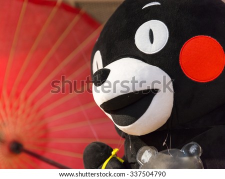 KUMAMOTO, JAPAN - November 3, 2014: Kumamon Doll hold Umbrella. Kumamon is a mascot of Kumamoto, The most popular mascot in Japan