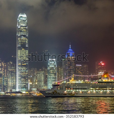HONG KONG - SEPTEMBER 6, 2013: Star Cruise MS Star Pisces with Hong Kong 1ifc (One ifc), 2IFC (Two ifc) Building,Skyline Cityscape Victoria Harbour Dramatic Cloudy Sky in Summer night