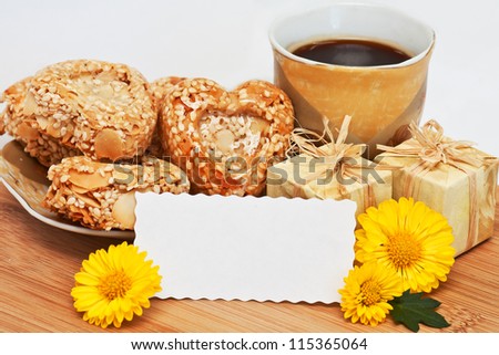 a cup of coffee with cookies, little gifts, yellow flowers and the place for the text