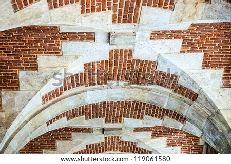 Brick background texture. Brick arch ceiling in Place des Vosges (Marais, Paris)