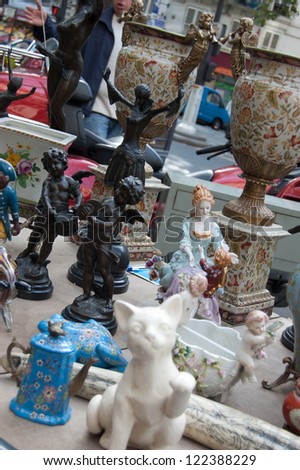 Flea market kitsch: figurines of angels, cat, teapots, vases. Paris, France.