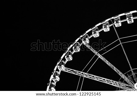 Closeup of white ferris wheel silhouette on black background. Quarter.