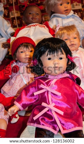 PARIS - JANUARY 6: Baby dolls in colorful clothes on sale at Trocadero Christmas market on January 6, 2013 in Paris, France. Trocadero  market is the one of biggest Christmas markets in Paris.