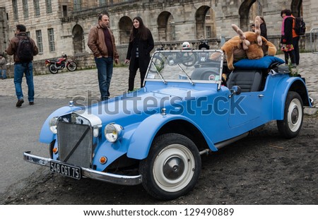 VINCENNES, FRANCE - JANUARY 6: Georges Irat car with funny elk toy takes part in antique cars exhibition on January 6, 2013 in Vincennes, France.