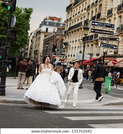 PARIS - APRIL 7: Unidentified young bride and groom as seen in Paris on April 7, 2012 in Paris, France. Paris is one of the most popular destination in the world for couples wishing to marry abroad.
