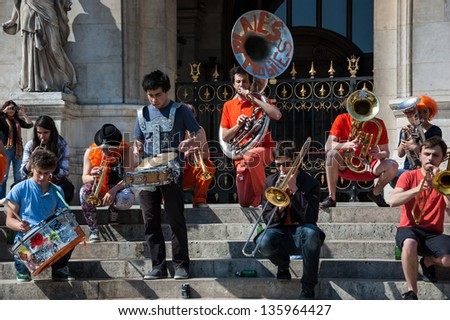PARIS - APRIL 21: Young brass band near Paris Opera building on April 21, 2013 in Paris, France. Dozens buskers perform on the streets and in metro of Paris.