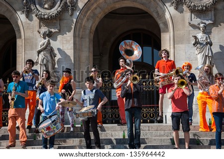 PARIS - APRIL 21: Young brass band near Paris Opera building on April 21, 2013 in Paris, France. Dozens buskers perform on the streets and in metro of Paris.