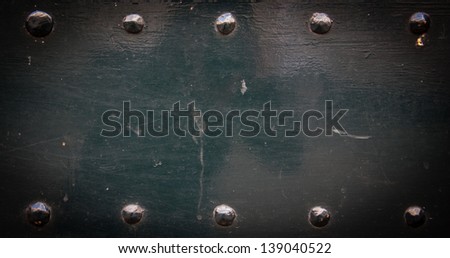 Old metal background with rivets. Vintage abstract texture with shading borders.