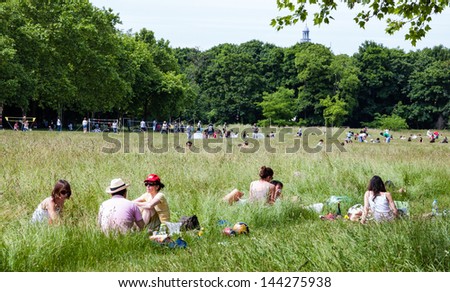 PARIS - JUNE 14: Unidentified people have picnic, rest, play and do sports in Vincennes forest on June 14, 2013 in Paris, France. Bois de Vincennes (Vincennes forest) is the largest park of Paris.