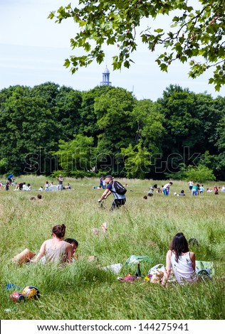 PARIS - JUNE 14: Unidentified people have picnic, rest, play and do sports in Vincennes forest on June 14, 2013 in Paris, France. Bois de Vincennes (Vincennes forest) is the largest park of Paris.