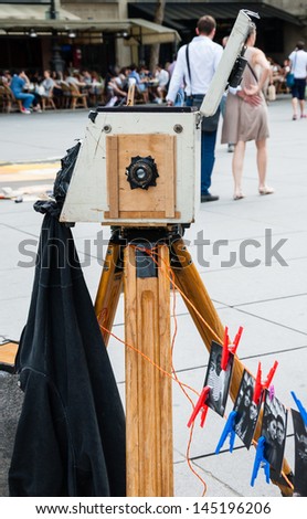 PARIS - JULY 6: Tourists are invited to take a picture by antique camera near Pompidou Centre on July 6, 2013 in Paris, France. Various artists show and sell their works at tourist hot spots in Paris.