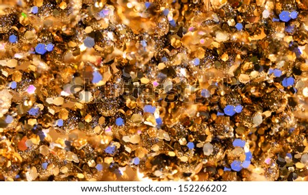 Festive golden sparkle background with violet spots.