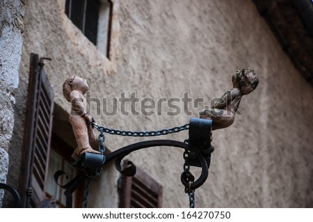 Waiting for God. Two chained figures look up. Salvation concept. Architectural detail.