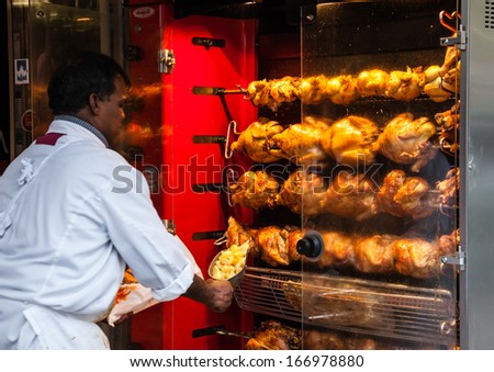 Paris - Nov 30: Unidentified Butcher Sells Traditional Roasted Chicken And Potatoes Near The Entrance To The Butcher Shop In The City Center On November 30, 2013 In Paris, France.