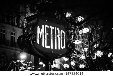 Paris Metro subway sign and Christmas illumination. Black and white. Retro style postcard.