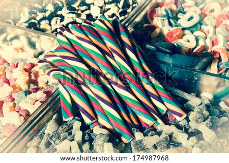 Collection of the colorful gummy and marshmellow candies at market. Toned image. Vintage food background. Bleached angles.