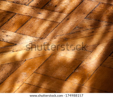 Old parquet floor in the morning light. Game of light and shadow.