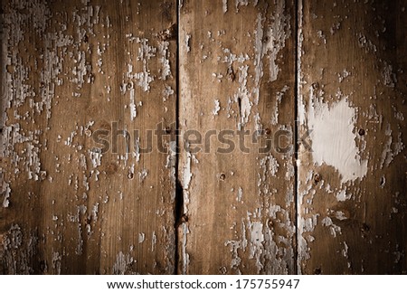 Texture of weathered wooden lining boards with peeling paint and rusty nail heads. Shadowed angles.