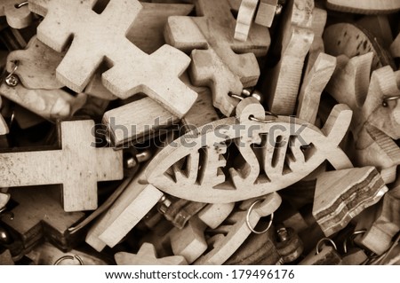 Different wooden crosses and Jesus fish symbol for sale at market in Old City of Jerusalem (Israel). Retro aged photo. Sepia.