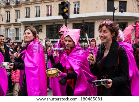 PARIS, FRANCE - MARCH 2, 2014: Unidentified participants in pink costumes at the Carnival in Paris. Colorful Carnaval de Paris is annual event, which history starts from the sixteenth century.