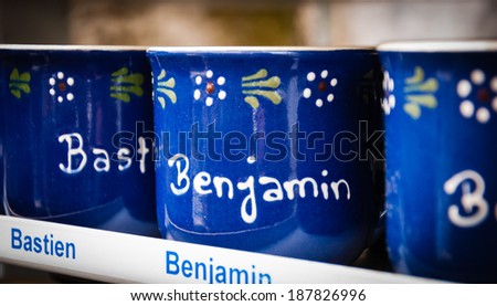 LES BAUX-DE-PROVENCE, FRANCE - MAY 16, 2013: Blue mugs with male names sold in souvenir shop. Les Baux-de-Provence, one of \
