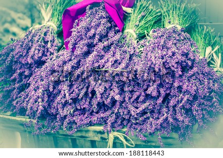 Bouquets of of dry lavender in wooden box. Outdoor. Rural background. Aged photo. Bleached angles.