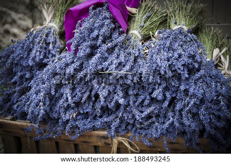 Bouquets of of dry lavender in wooden box. Outdoor. Rural background. Aged photo. Shadowed angles.