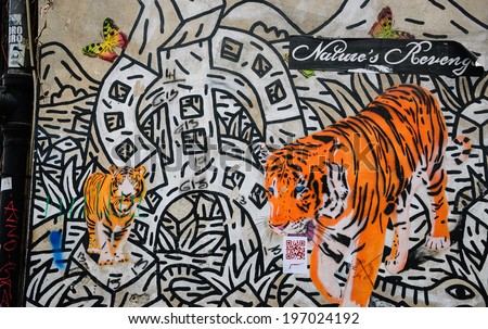 PARIS, FRANCE - APRIL 20, 2013: Nature\'s revenge graffiti on the wall in Marais quarter. In past decades graffiti became and important element of urban culture in Paris.