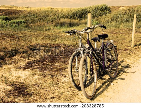 Two bicycles in countryside. Brittany, France. The concept of romance, love and simple everyday life. Aged photo.