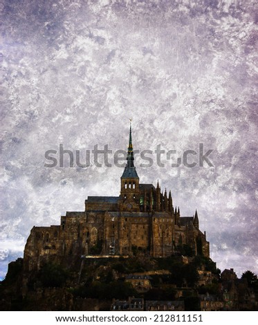 Mont Saint Michel UNESCO heritage site under cloudy sky. Normandy, France. Retro aged photo with scratches.